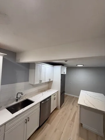 a kitchen with a sink and cabinets