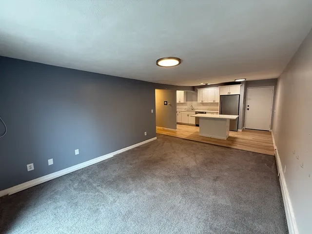 a view of empty room with a fireplace