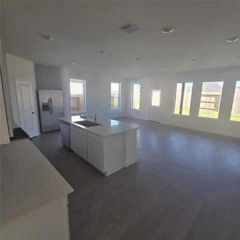 a view of a big room with windows and chandelier