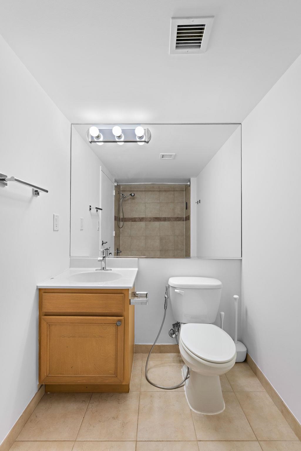 700 1st Street, Unit 3E Hoboken, NJ 07030 - Photo 11 of 16 a bathroom with a toilet sink and mirror