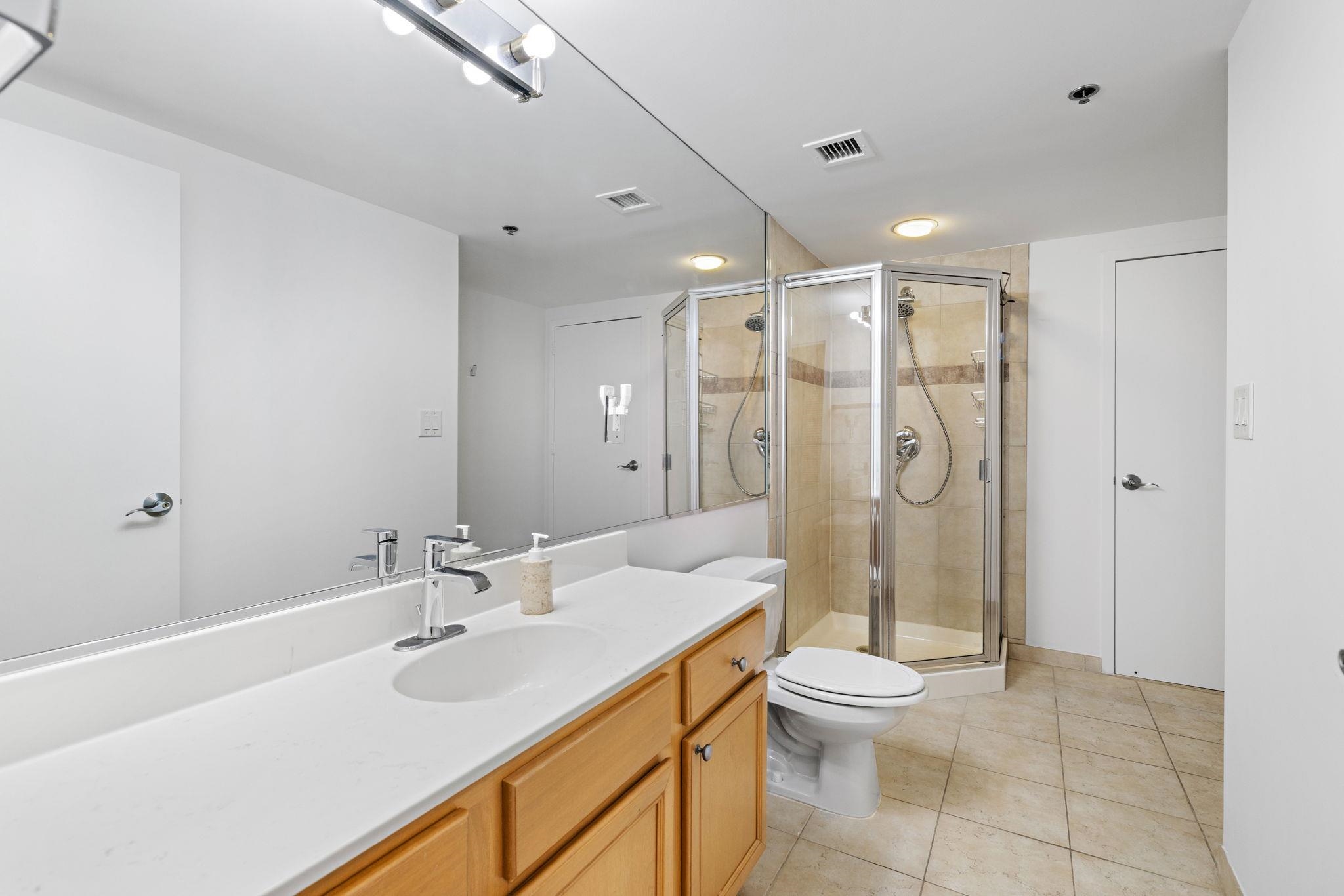 700 1st Street, Unit 3E Hoboken, NJ 07030 - Photo 12 of 16 a bathroom with a shower sink vanity mirror and toilet