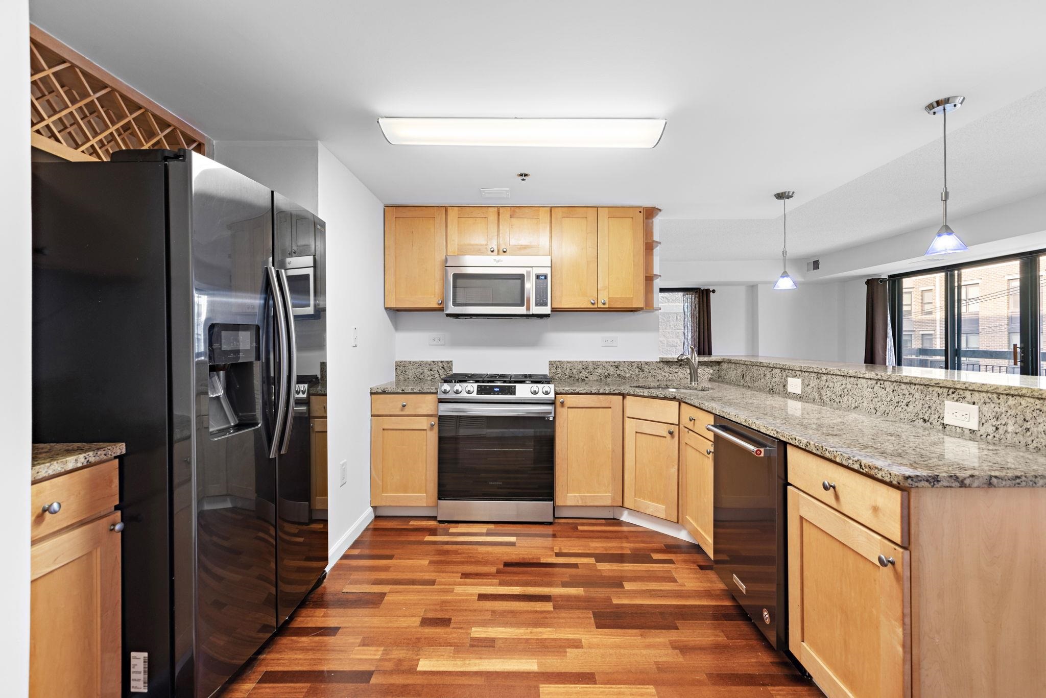 700 1st Street, Unit 3E Hoboken, NJ 07030 - Photo 3 of 16 a kitchen with stainless steel appliances granite countertop a refrigerator and a sink