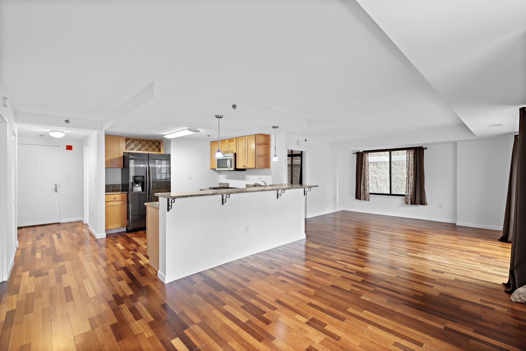 700 1st Street, Unit 3E Hoboken, NJ 07030 - Photo 5 of 16 a view of a kitchen with wooden floor and a refrigerator