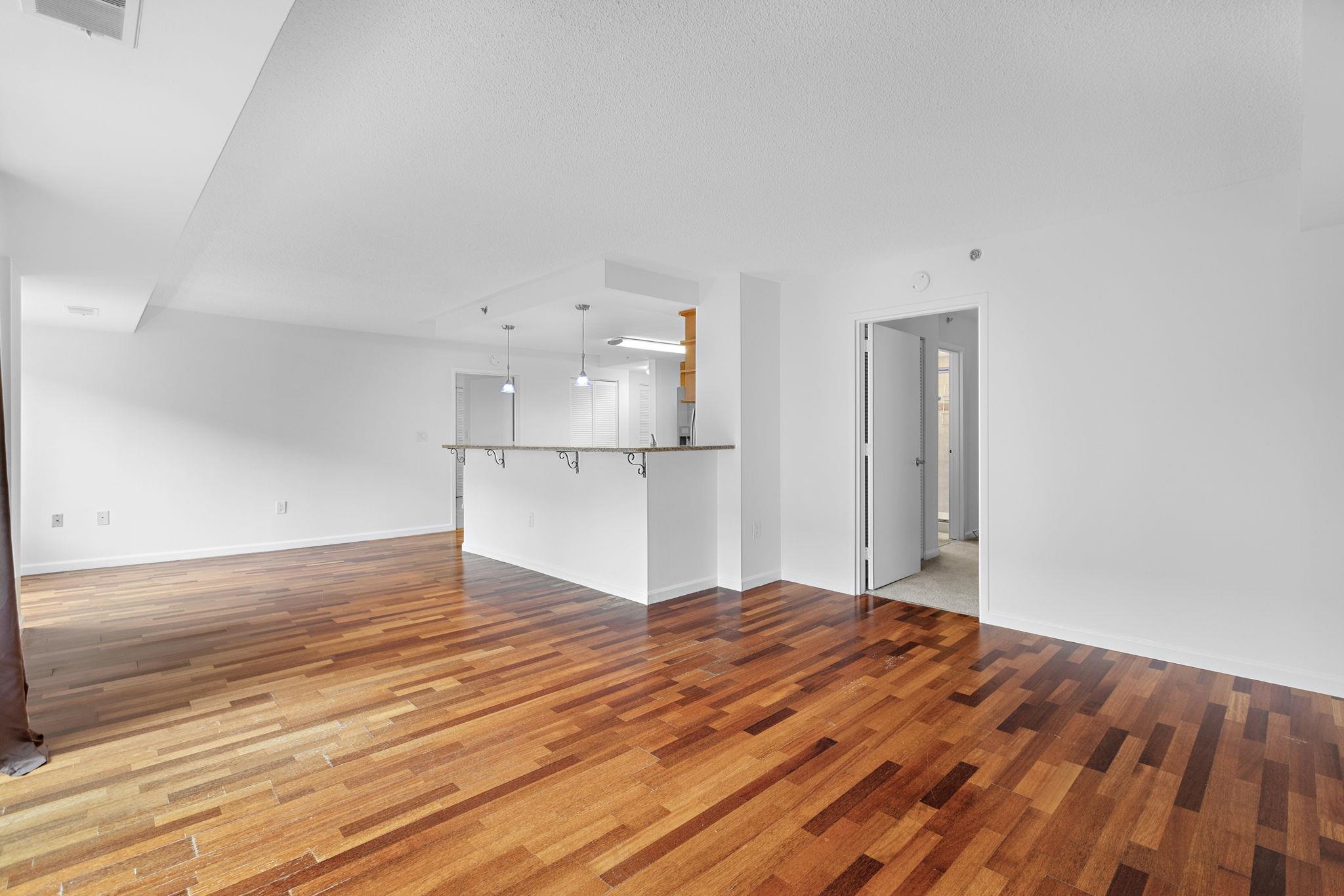 700 1st Street, Unit 3E Hoboken, NJ 07030 - Photo 8 of 16 a view of a kitchen with wooden floor and a sink