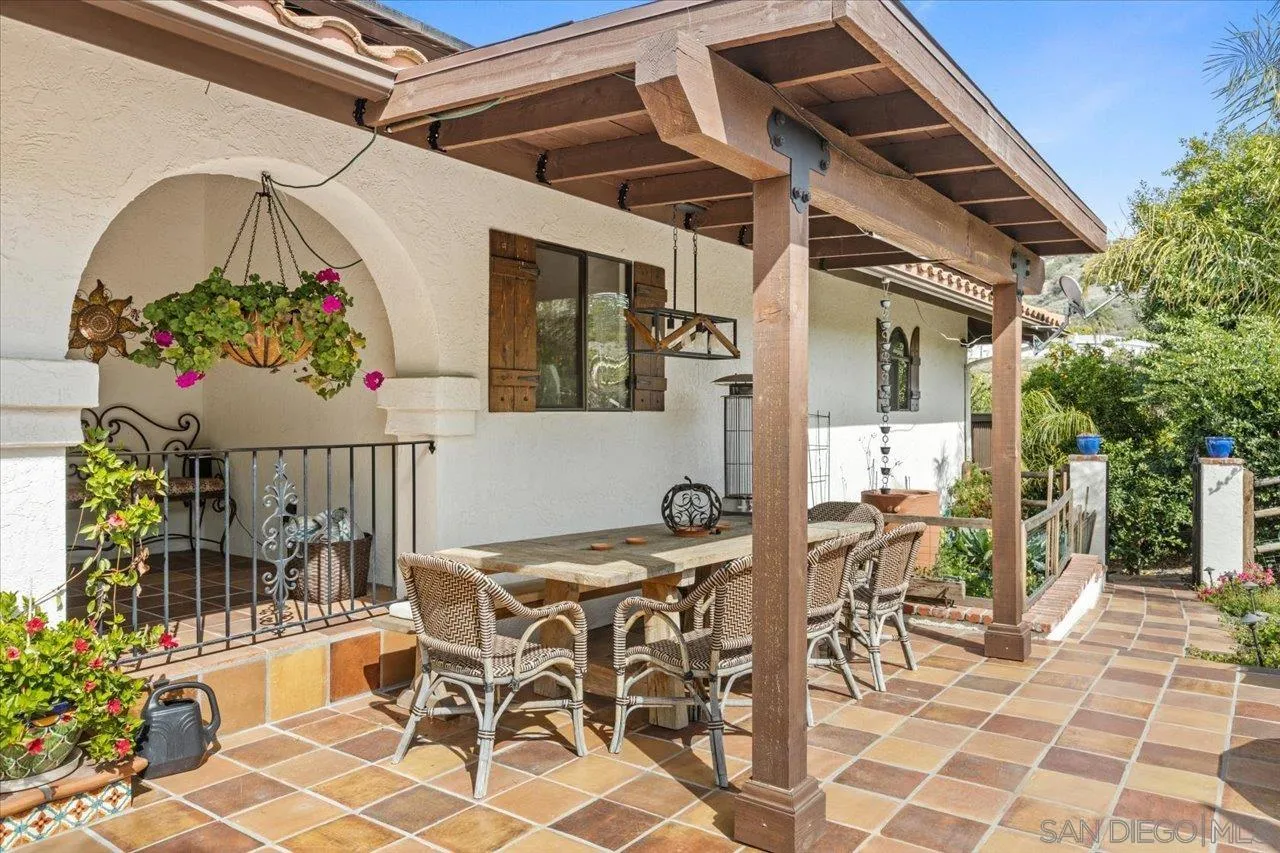 1379 Sunny Heights Road Fallbrook, CA 92028 - Photo 15 of 64 a view of a patio with table and chairs potted plants