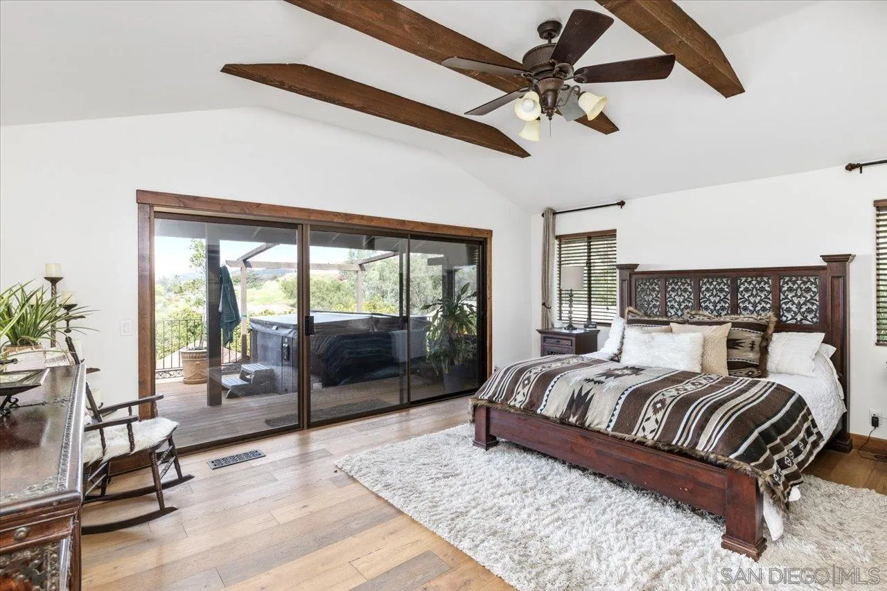 1379 Sunny Heights Road Fallbrook, CA 92028 - Photo 23 of 64 a bedroom with a large bed and a large window