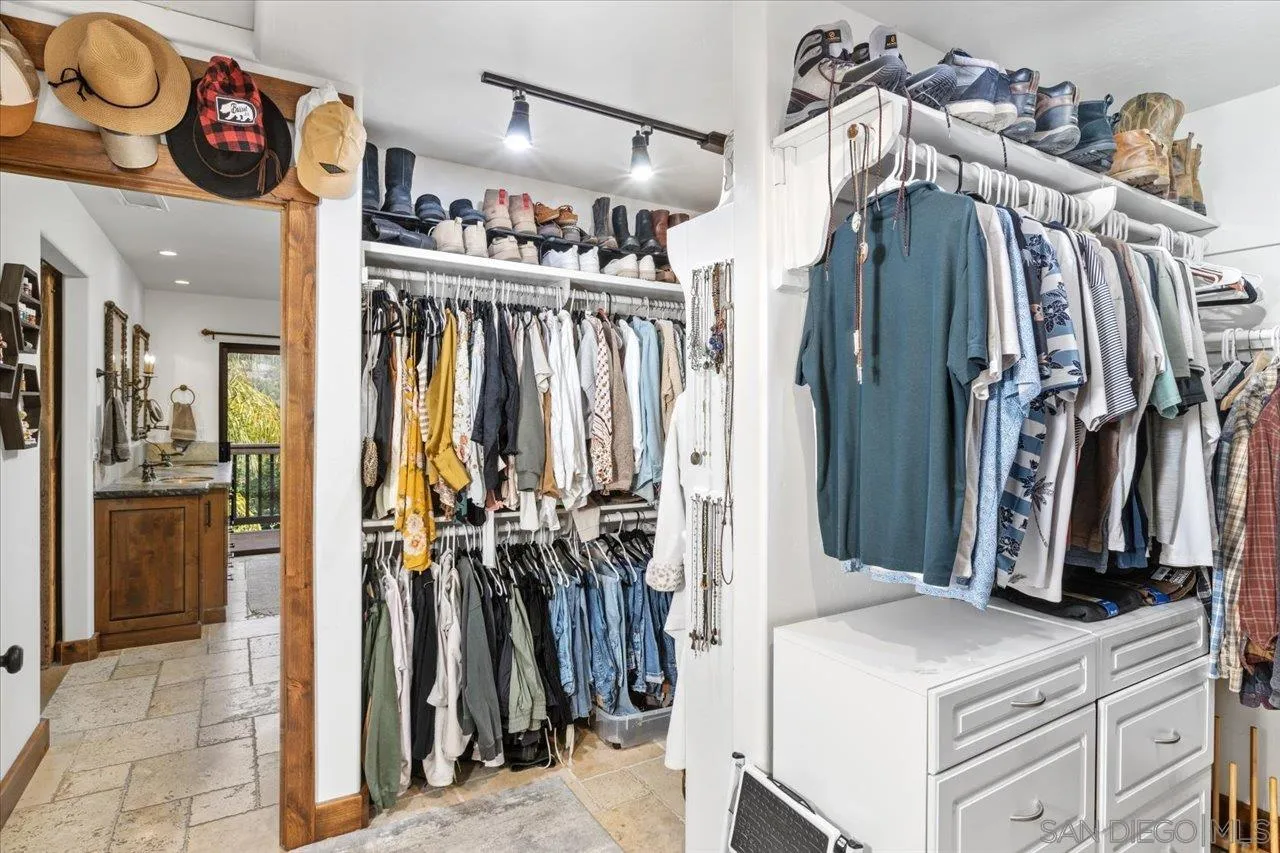 1379 Sunny Heights Road Fallbrook, CA 92028 - Photo 28 of 64 a view of walk in closet with clothes and shoes