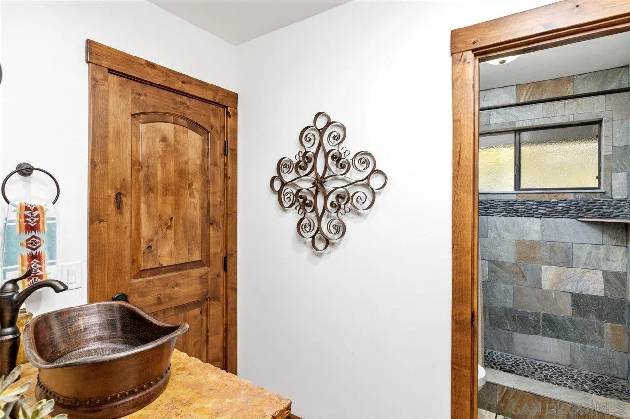 1379 Sunny Heights Road Fallbrook, CA 92028 - Photo 30 of 64 a bathroom with a sink and a mirror