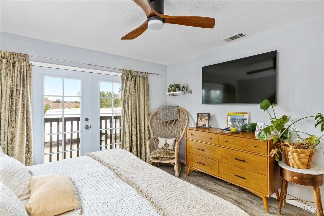 1379 Sunny Heights Road Fallbrook, CA 92028 - Photo 40 of 64 a bedroom with a bed and flat tv screen on the dresser