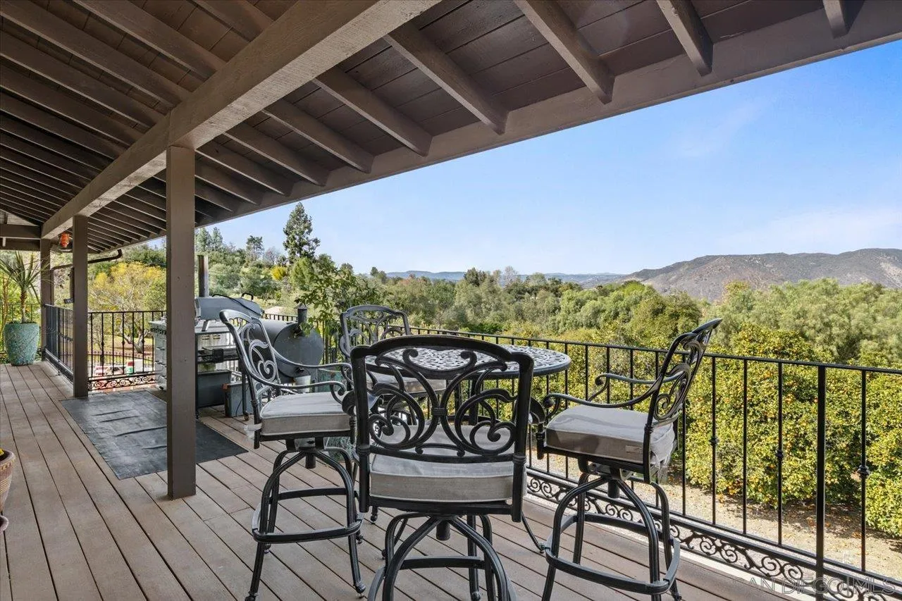 1379 Sunny Heights Road Fallbrook, CA 92028 - Photo 4 of 64 a view of a chairs and table in patio with wooden floor