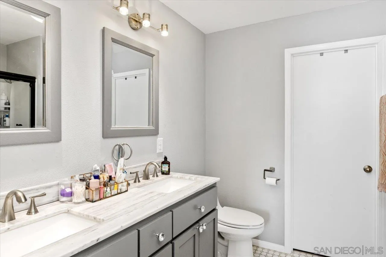 1379 Sunny Heights Road Fallbrook, CA 92028 - Photo 41 of 64 a bathroom with a granite countertop sink toilet and mirror