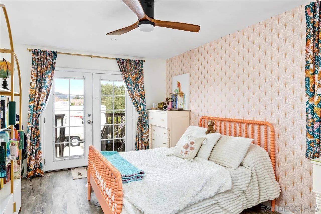 1379 Sunny Heights Road Fallbrook, CA 92028 - Photo 42 of 64 a bedroom with a bed and a chandelier