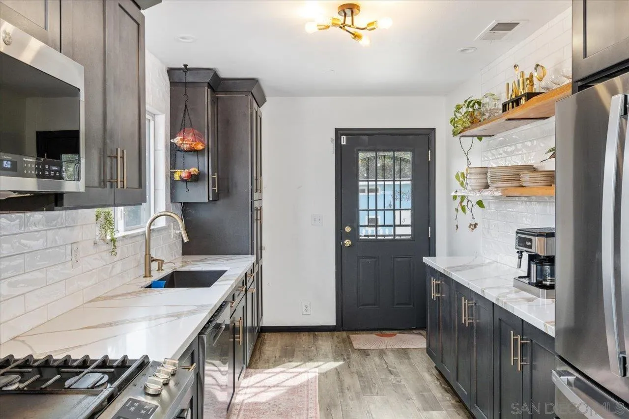 1379 Sunny Heights Road Fallbrook, CA 92028 - Photo 45 of 64 a kitchen with stainless steel appliances granite countertop a sink a stove and a refrigerator