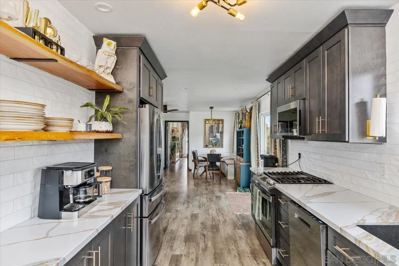 1379 Sunny Heights Road Fallbrook, CA 92028 - Photo 46 of 64 a kitchen with stainless steel appliances granite countertop a sink stove and refrigerator