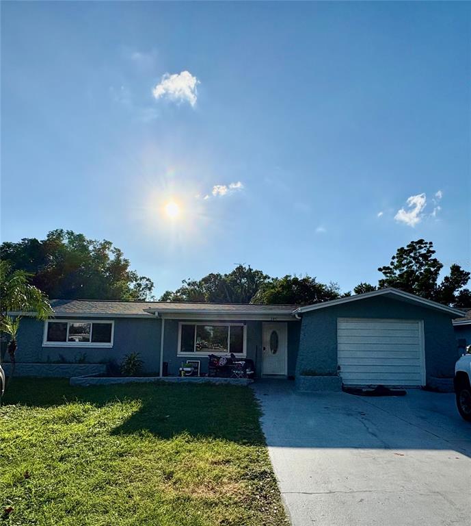 3841 Chaffey Drive New Port Richey, FL 34652 - Photo 1 of 2 a front view of a house with garden