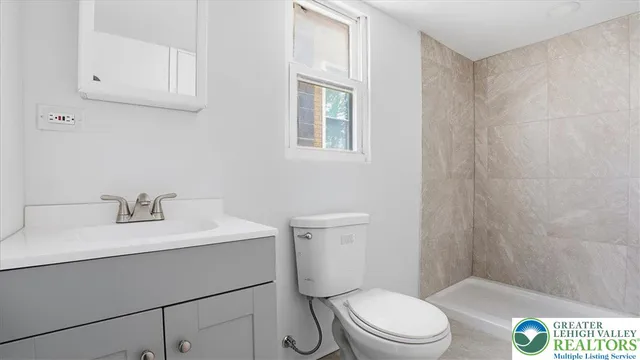 a bathroom with a sink a toilet and vanity