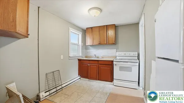 a kitchen with a stove cabinets and a refrigerator