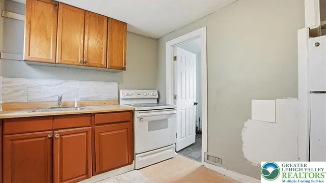 a white toilet sitting next to a bathroom sink