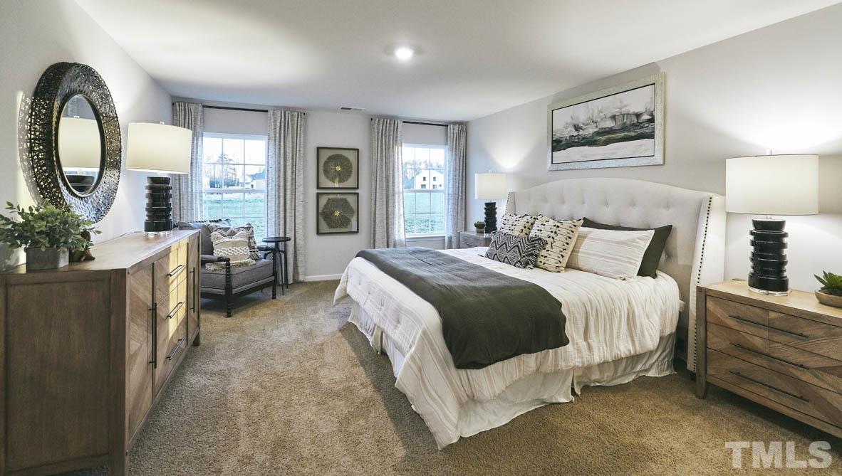 4032 Water Wheel Road Rocky Mount, NC 27803 - Photo 15 of 29 a spacious bedroom with a bed a mirror and a large window