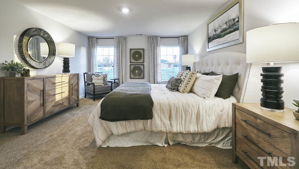 4032 Water Wheel Road Rocky Mount, NC 27803 - Photo 16 of 29 a bedroom with a bed a mirror and a large window