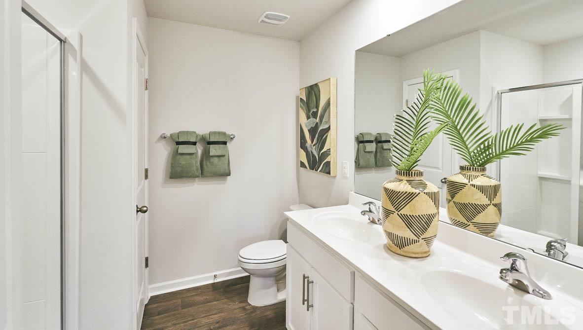 4032 Water Wheel Road Rocky Mount, NC 27803 - Photo 17 of 29 a bathroom with a sink a toilet and mirror