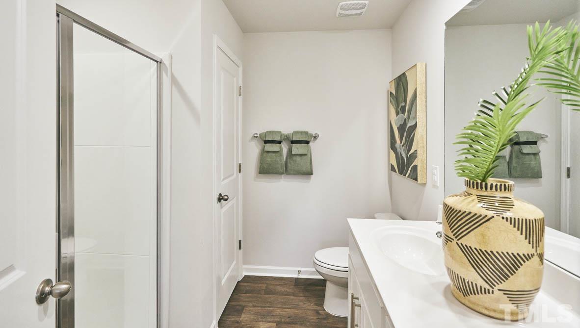 4032 Water Wheel Road Rocky Mount, NC 27803 - Photo 18 of 29 a bathroom with a toilet a sink and shower