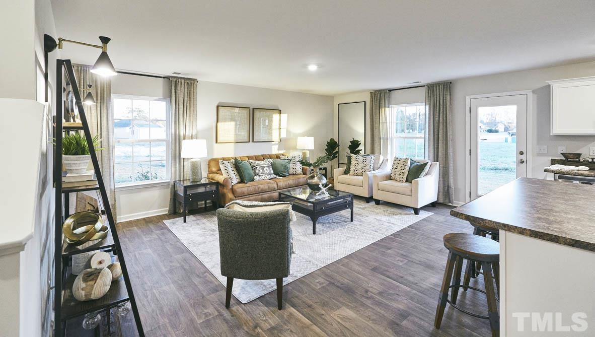 4032 Water Wheel Road Rocky Mount, NC 27803 - Photo 6 of 29 a living room with furniture floor to ceiling window and wooden floor