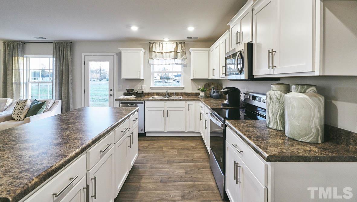 4032 Water Wheel Road Rocky Mount, NC 27803 - Photo 8 of 29 a kitchen with granite countertop a sink a counter top space appliances and cabinets