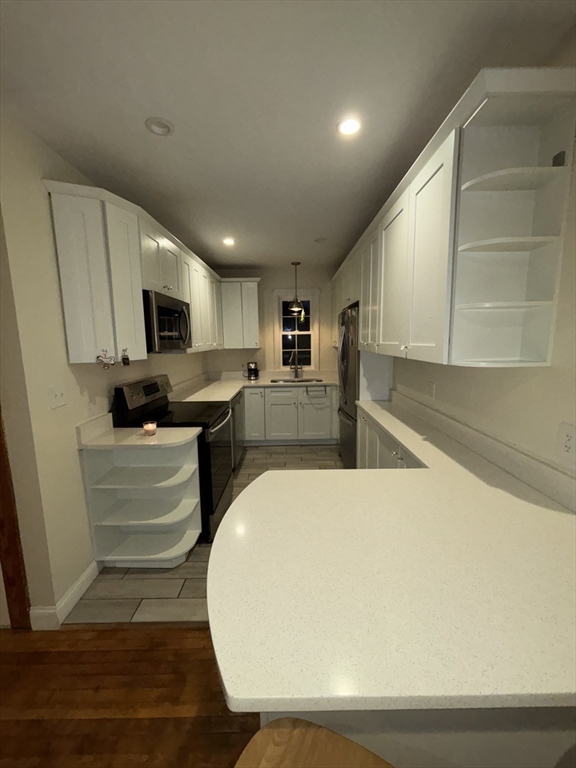 19 Aldena Road Worcester, MA 01603 - Photo 5 of 15 a view of kitchen with microwave stove refrigerator and cabinets
