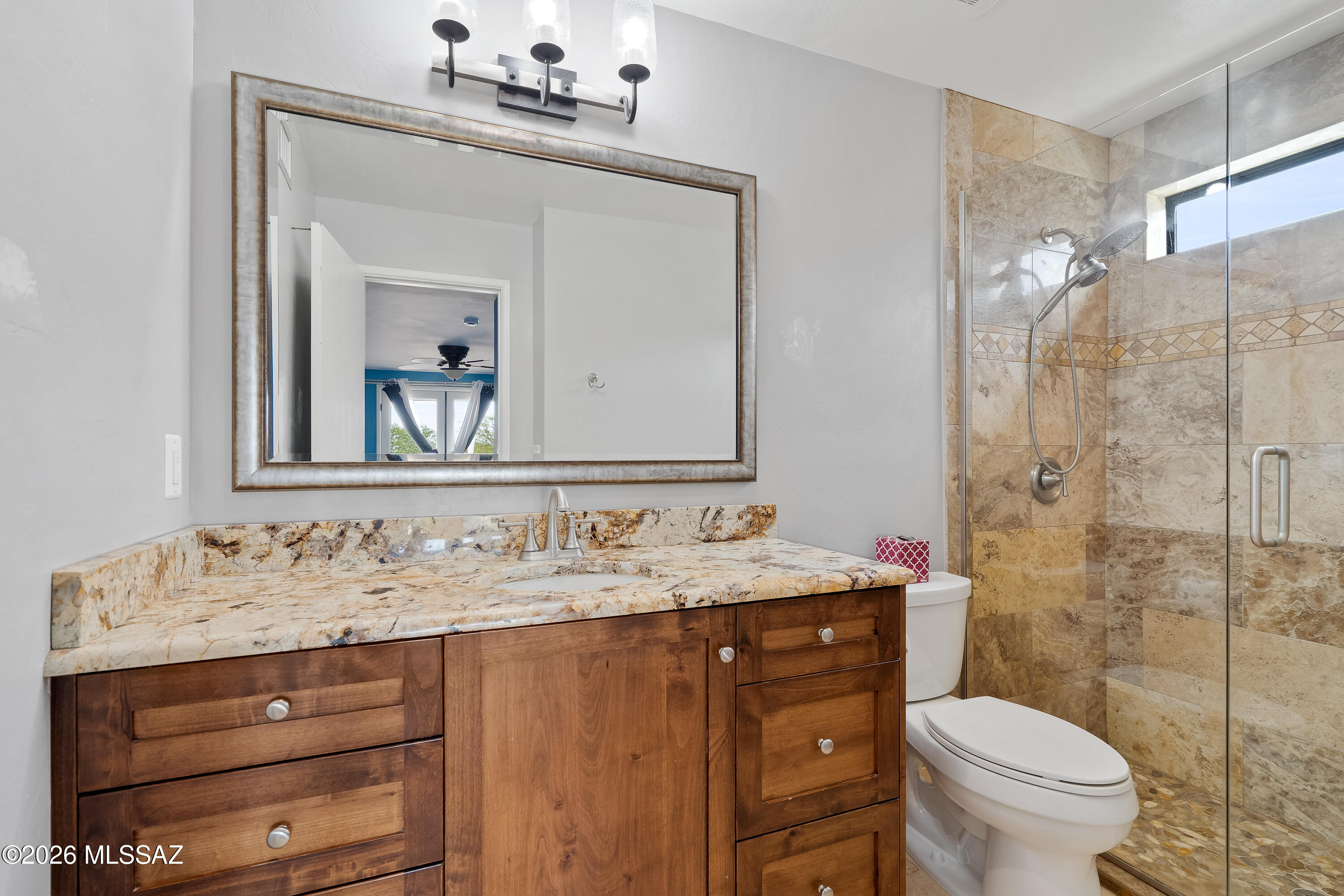 9420 East Ravine Trail Tucson, AZ 85749 - Photo 17 of 39 a bathroom with a sink vanity mirror and toilet