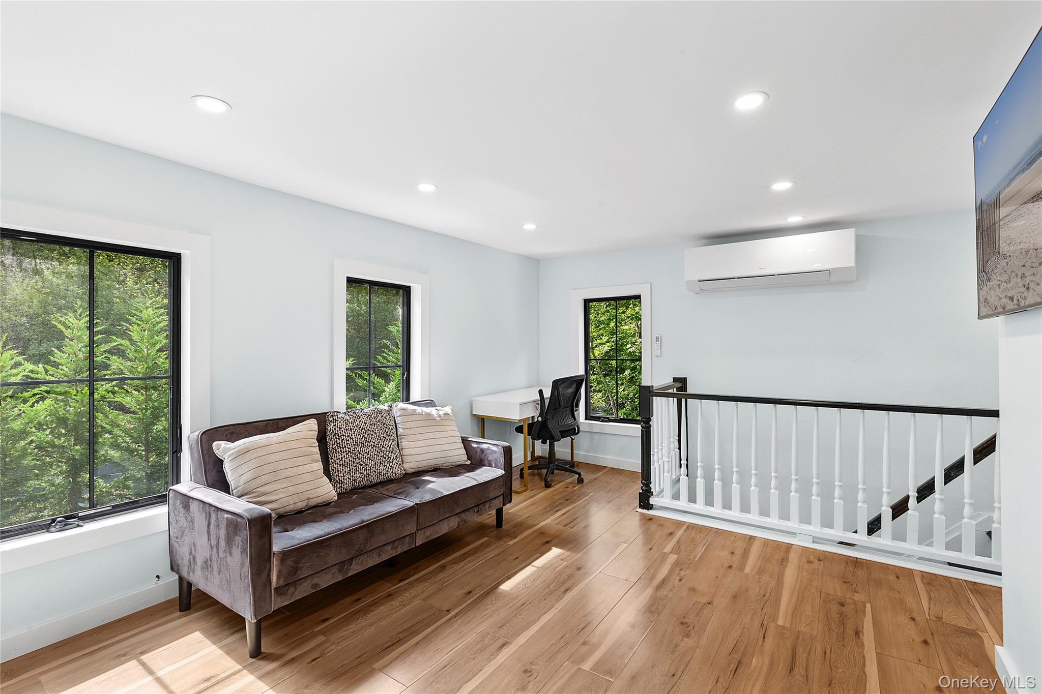 73175 Main Road Greenport, NY 11944 - Photo 11 of 15 Living area featuring a desk, light wood-style flooring, recessed lighting, and an AC wall unit
