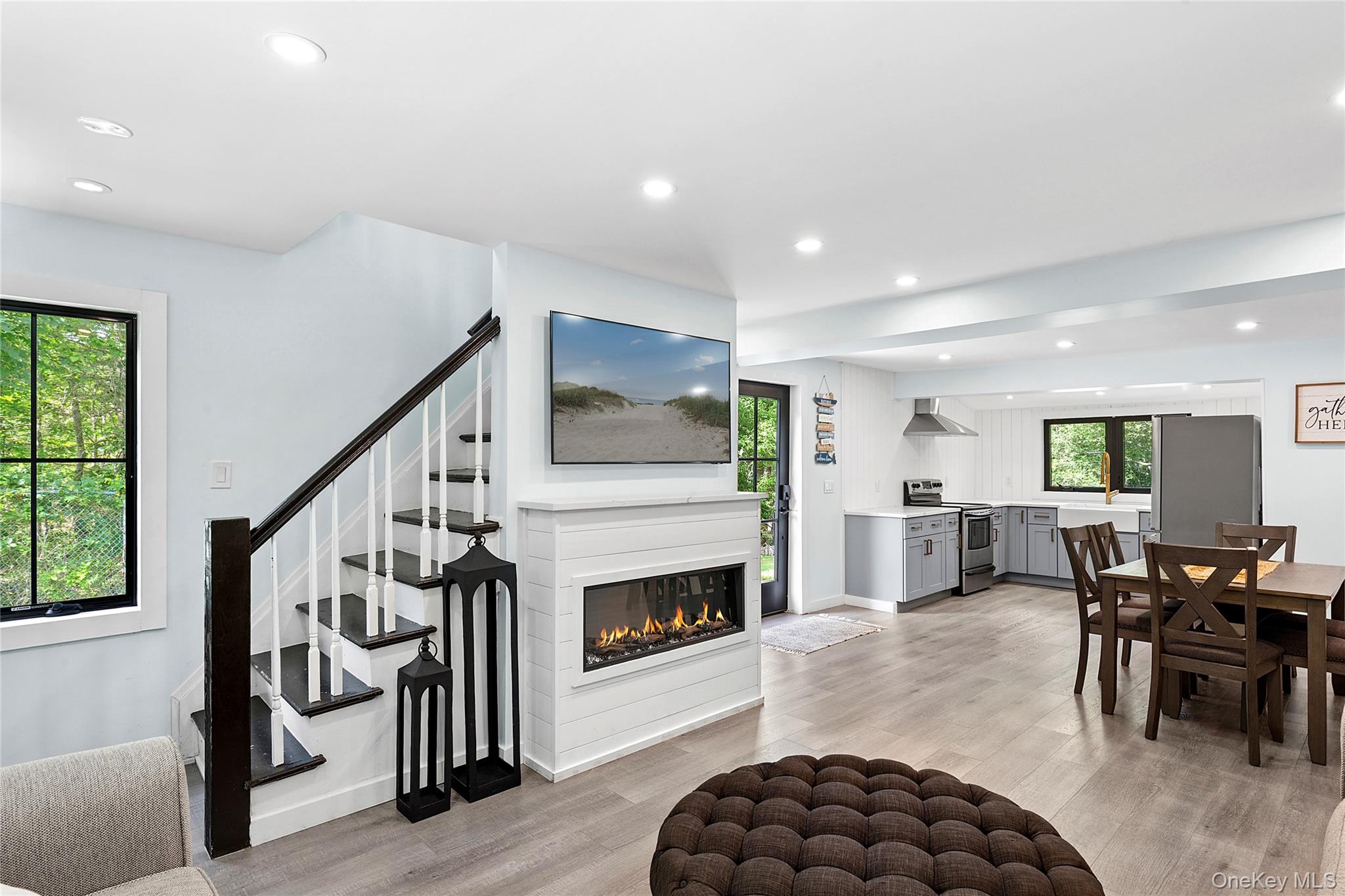 73175 Main Road Greenport, NY 11944 - Photo 4 of 15 Dining area featuring recessed lighting, light wood-style flooring, and a glass covered fireplace