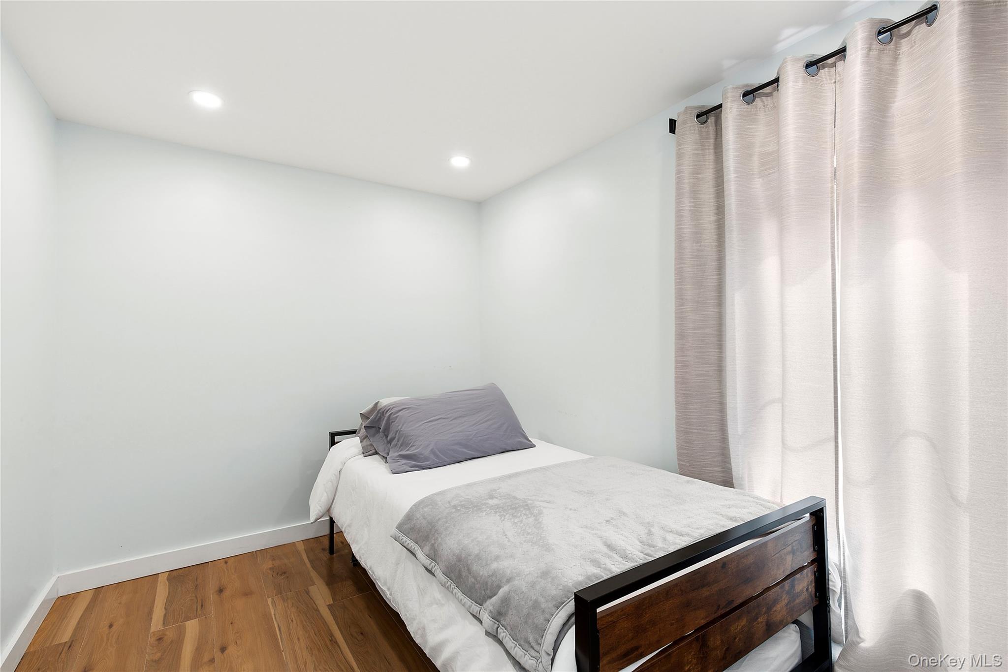 73175 Main Road Greenport, NY 11944 - Photo 10 of 15 Bedroom featuring wood finished floors and recessed lighting