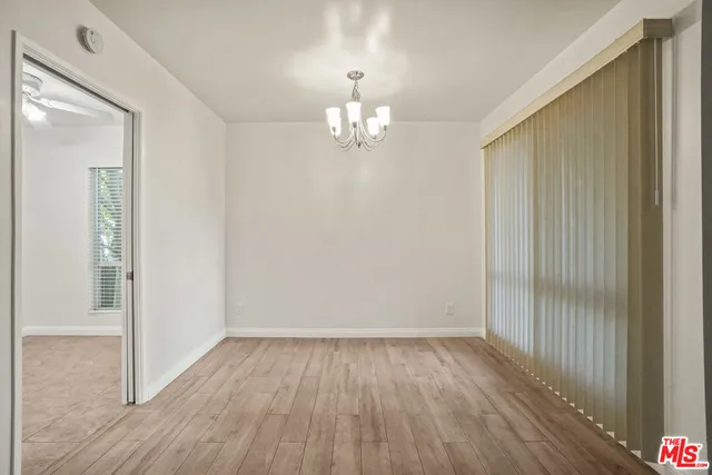 a view of a livingroom with wooden floor and a large window