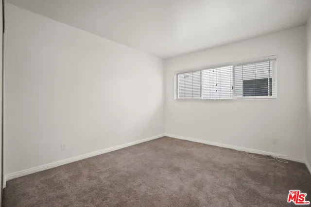 a bathroom with a granite countertop sink toilet a mirror and shower