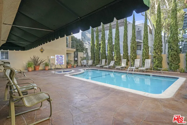 a view of a house with swimming pool and sitting area