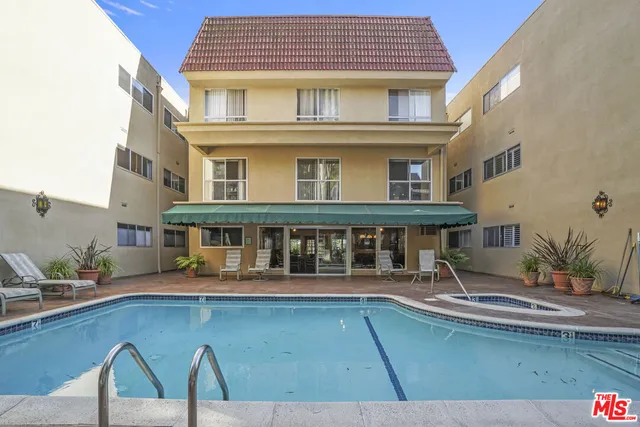 a living room with furniture and large windows
