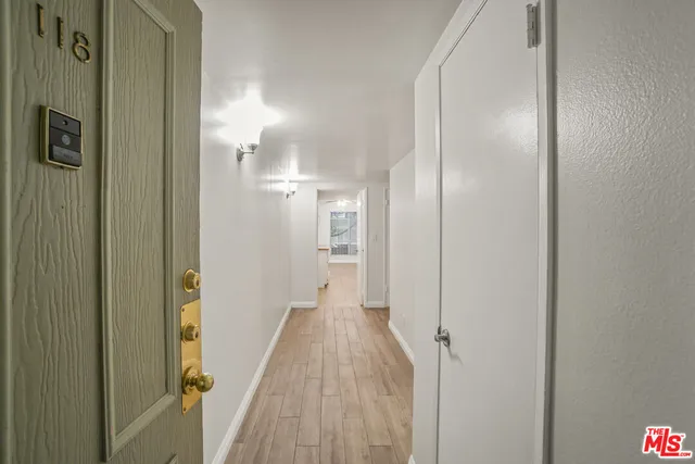 a view of a hallway with wooden floor