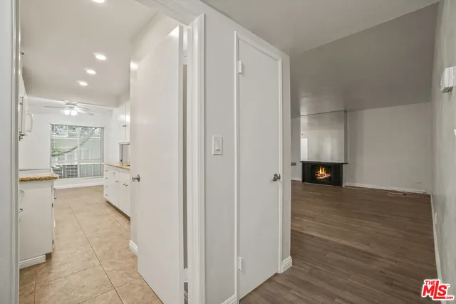 a kitchen with granite countertop a sink and white cabinets