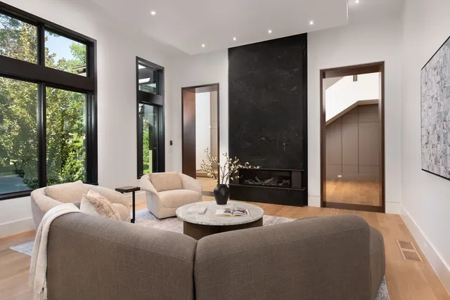 a bedroom with a bed and large windows