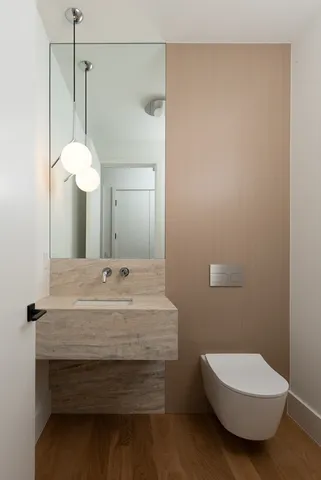 a bathroom with a sink a toilet and a mirror