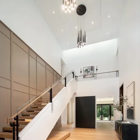 a view of entryway and hall with wooden floor