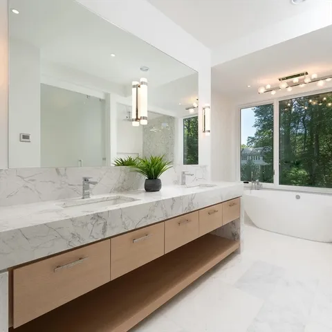 a large bathroom with a large tub and sink