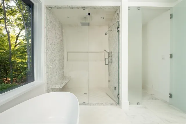 a bathroom with a bathtub and shower
