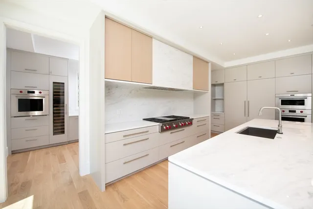 a kitchen with a stove a sink and a refrigerator