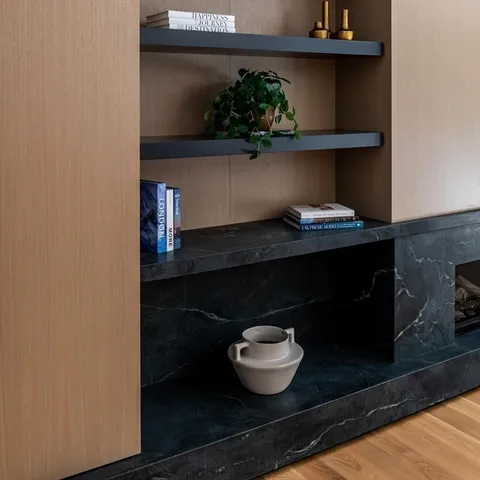 a living room with a table and potted plant