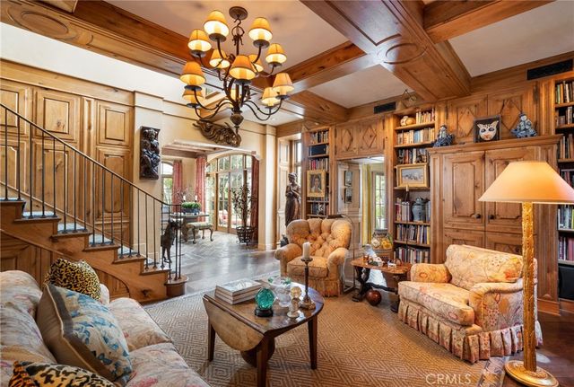 a living room with furniture a chandelier and a chandelier