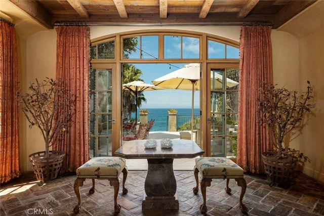 a view of a patio with table and chairs and potted plants