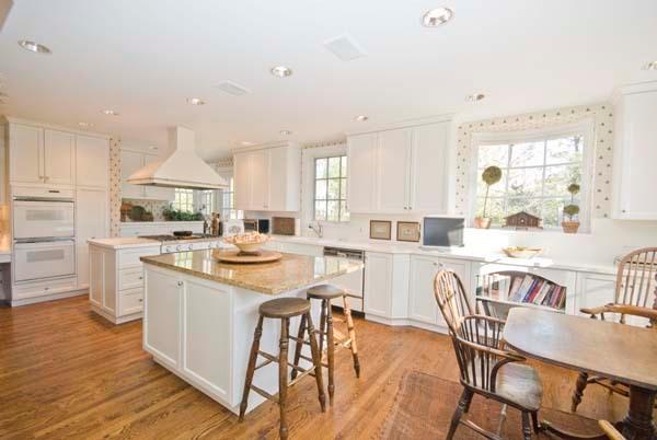 969 Hill Road Winnetka, IL 60093 - Photo 14 of 25 a kitchen with stainless steel appliances kitchen island granite countertop a stove a sink a dining table and chairs