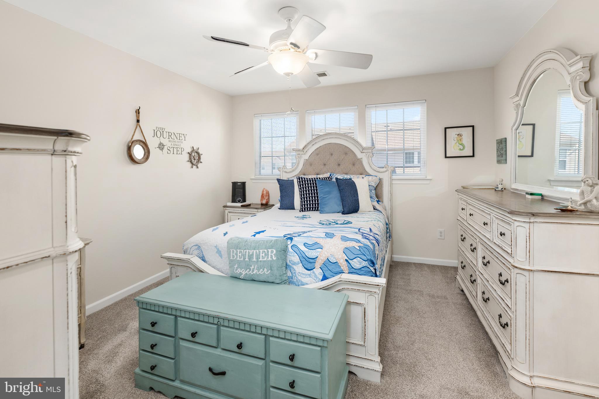 27548 Mayfield Road, Unit 42 Millsboro, DE 19966 - Photo 17 of 46 a bedroom with a bed a chandelier and a mirror